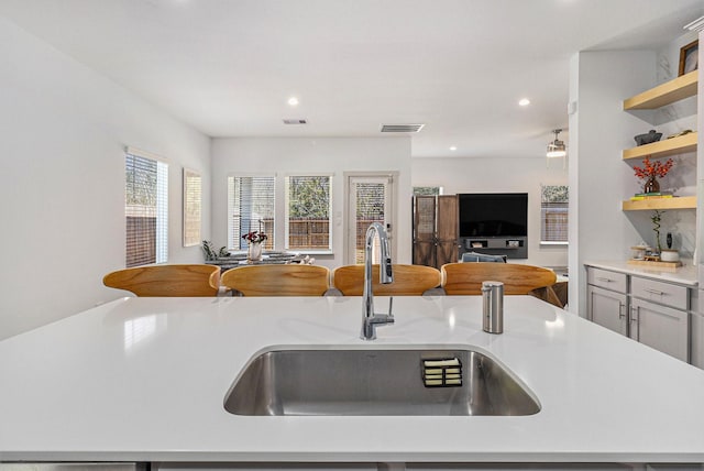 12823 Tokenhouse Ln, Houston, TX 77047 - kitchen featuring open floor plan, a sink, open shelves, light countertops, and recessed lighting