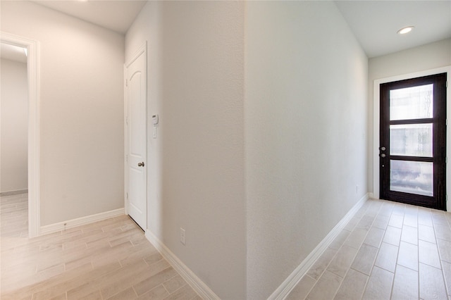 hall with wood tiled floor, baseboards, and recessed lighting