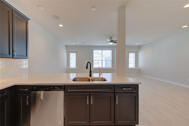 kitchen with ceiling fan, dishwasher, a sink, light countertops, and light wood-style flooring