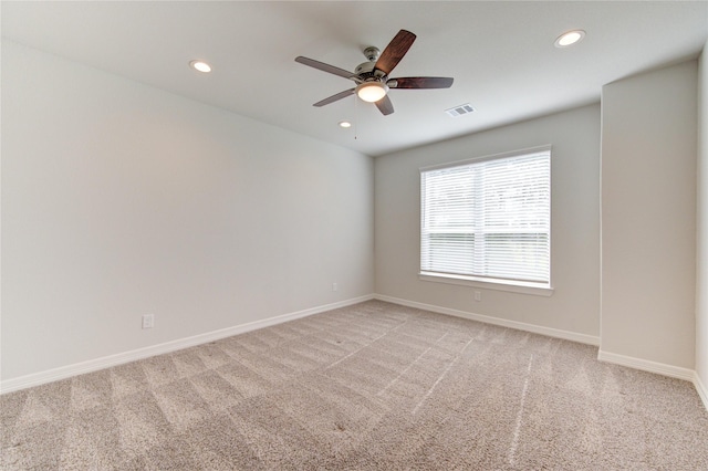empty room featuring light colored carpet, recessed lighting, and visible vents
