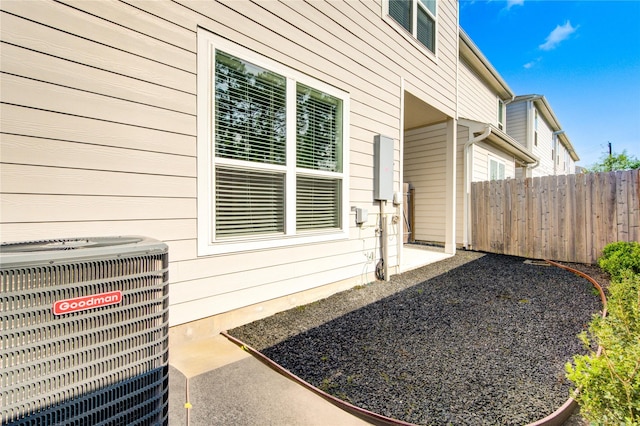 exterior space featuring a patio, fence, and central AC unit