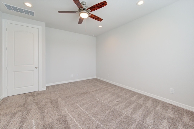 empty room featuring carpet floors, recessed lighting, a ceiling fan, and visible vents