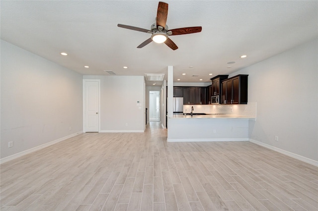 unfurnished living room with light wood-style floors, baseboards, ceiling fan, and recessed lighting