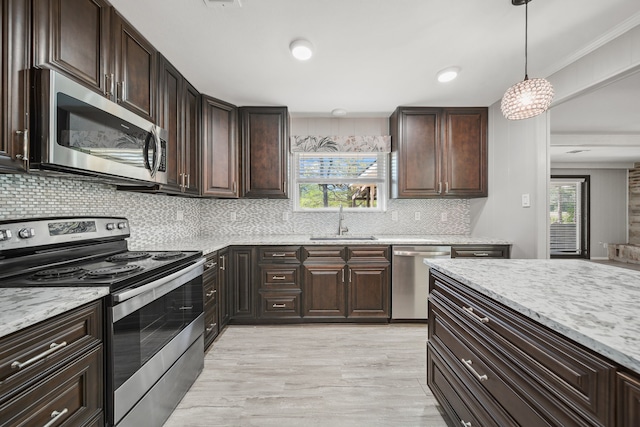 29133 E Lake Dr, Hempstead, TX 77445 - kitchen with appliances with stainless steel finishes, decorative backsplash, a sink, and light stone counters