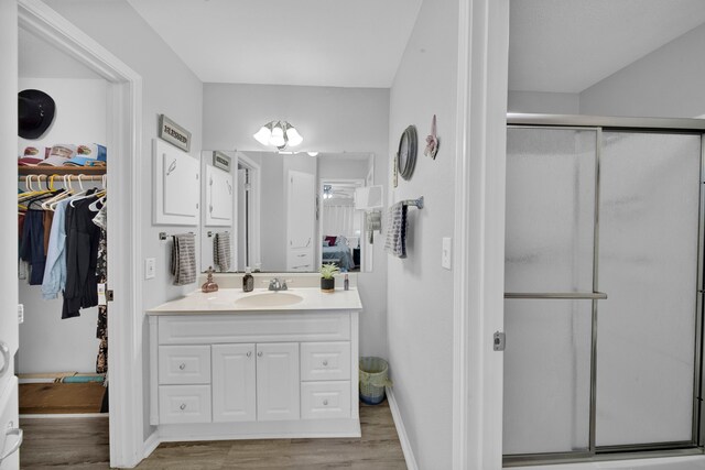 29133 E Lake Dr, Hempstead, TX 77445 - full bath with vanity, a walk in closet, wood finished floors, and a shower stall