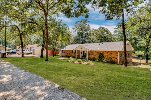 29133 E Lake Dr, Hempstead, TX 77445 - single story home featuring a front yard, a garage, brick siding, fence, and gravel driveway
