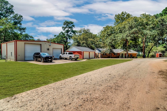 29133 E Lake Dr, Hempstead, TX 77445 - view of front of property with a detached garage, dirt driveway, an outdoor structure, and a front yard