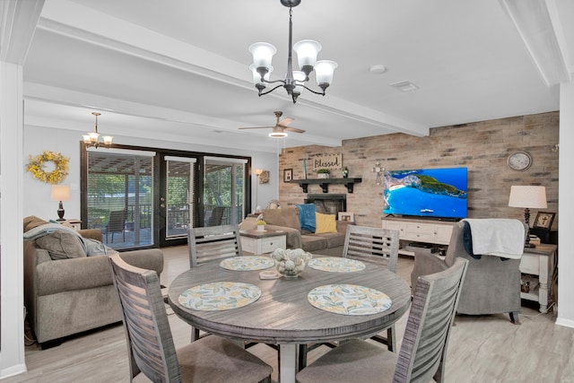 29133 E Lake Dr, Hempstead, TX 77445 - dining area featuring wood walls, visible vents, beam ceiling, and an accent wall