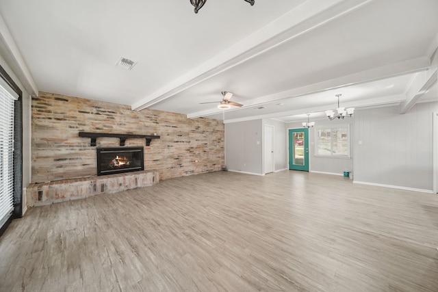 29133 E Lake Dr, Hempstead, TX 77445 - unfurnished living room with a fireplace, ceiling fan with notable chandelier, wood finished floors, beamed ceiling, and visible vents