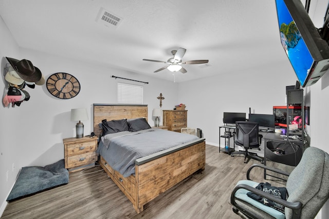 29133 E Lake Dr, Hempstead, TX 77445 - bedroom with baseboards, ceiling fan, wood finished floors, and visible vents