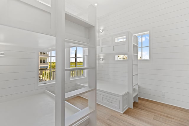 11365 Beachside Dr, Galveston, TX 77554 - mudroom featuring light wood-style flooring, plenty of natural light, and wooden walls