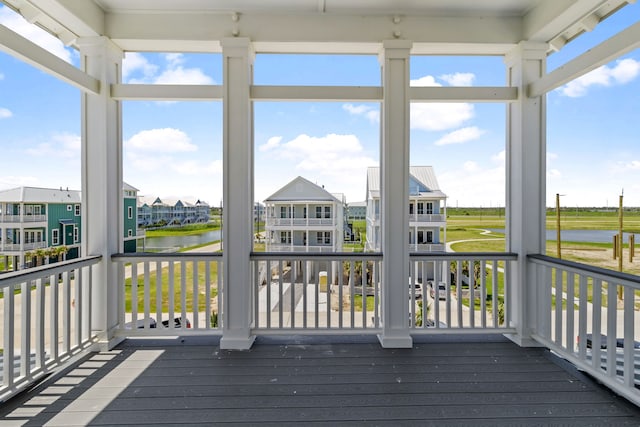 11365 Beachside Dr, Galveston, TX 77554 - unfurnished sunroom with a water view, plenty of natural light, and a residential view