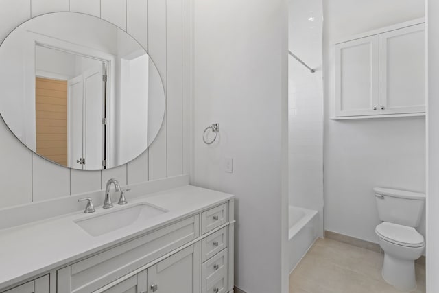 11365 Beachside Dr, Galveston, TX 77554 - full bath with toilet, vanity, tile patterned floors, shower / bathtub combination, and baseboards