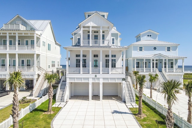 11365 Beachside Dr, Galveston, TX 77554 - raised beach house featuring stairway, covered porch, board and batten siding, and a garage