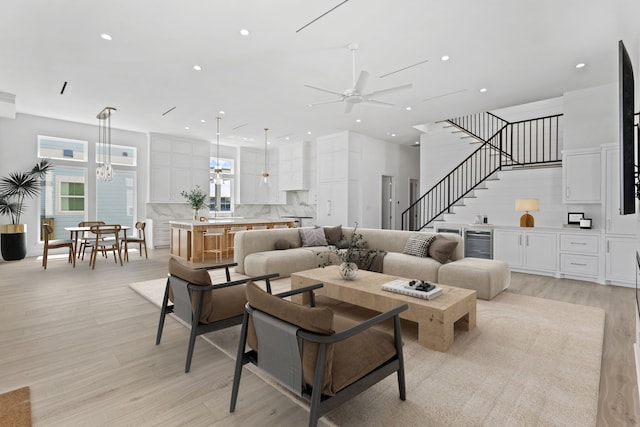 11365 Beachside Dr, Galveston, TX 77554 - living room with beverage cooler, ceiling fan, light wood-style floors, recessed lighting, and stairway