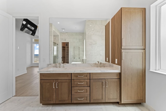 11365 Beachside Dr, Galveston, TX 77554 - bathroom with a shower stall, double vanity, and baseboards