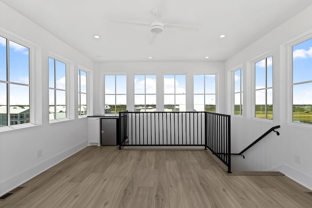 11365 Beachside Dr, Galveston, TX 77554 - unfurnished sunroom featuring wood finished floors, plenty of natural light, recessed lighting, and baseboards
