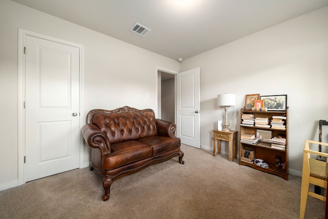 living area with carpet flooring, baseboards, and visible vents