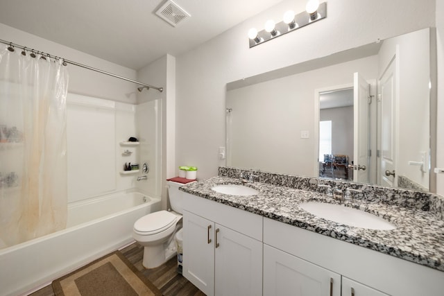full bath featuring a sink, visible vents, toilet, and shower / tub combo