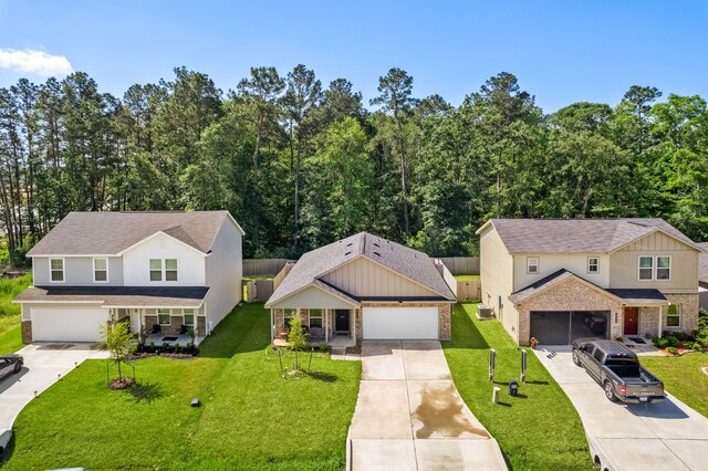 view of front of house featuring concrete driveway, a front yard, and brick siding