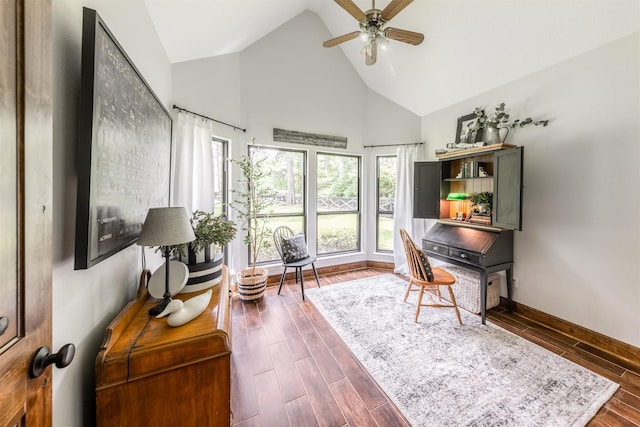 office featuring baseboards, a ceiling fan, high vaulted ceiling, and wood finished floors