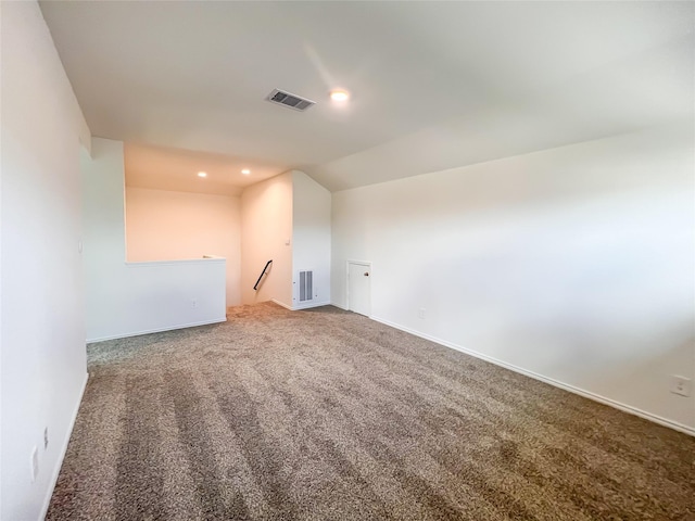 additional living space with visible vents, recessed lighting, carpet floors, and lofted ceiling