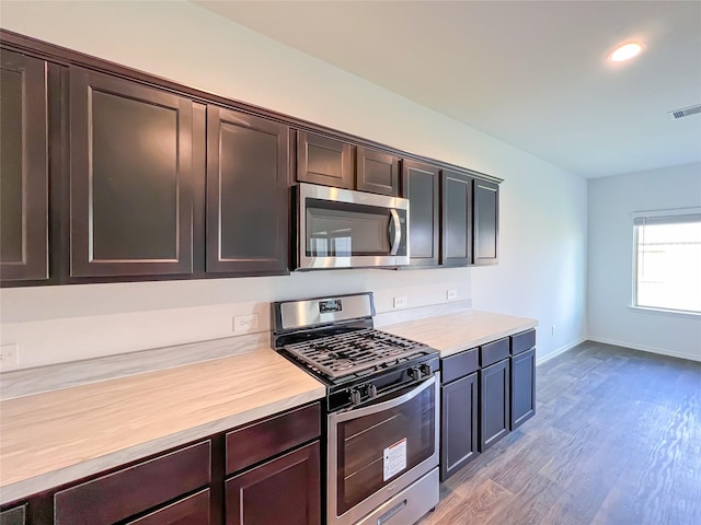 kitchen with light countertops, appliances with stainless steel finishes, and light wood-type flooring