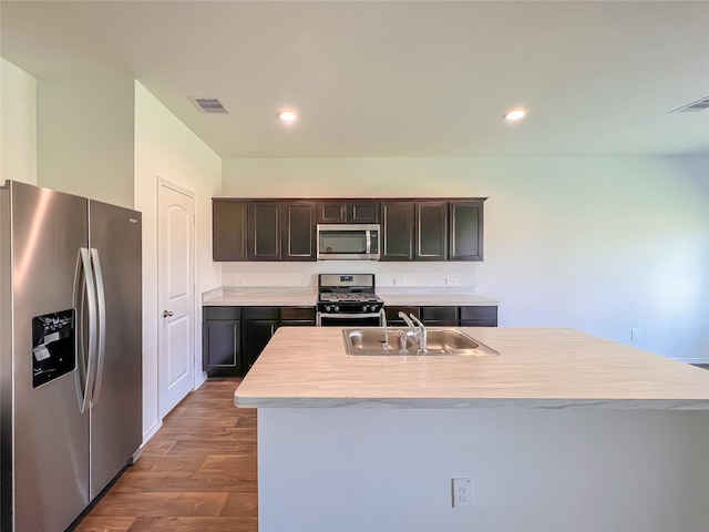 kitchen with a sink, light countertops, stainless steel appliances, and visible vents