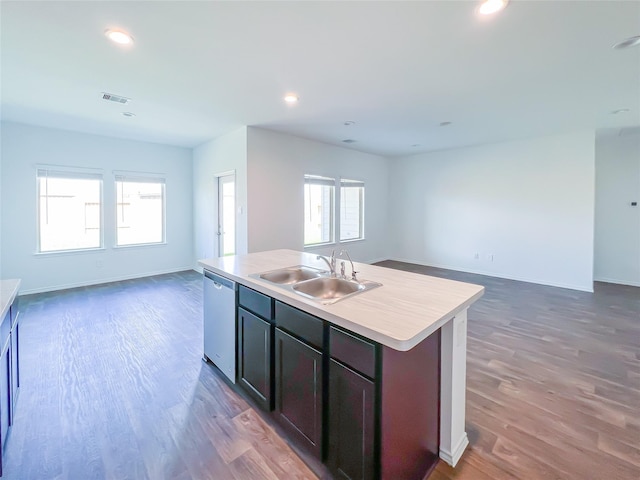 kitchen with a sink, a wealth of natural light, open floor plan, and dishwasher