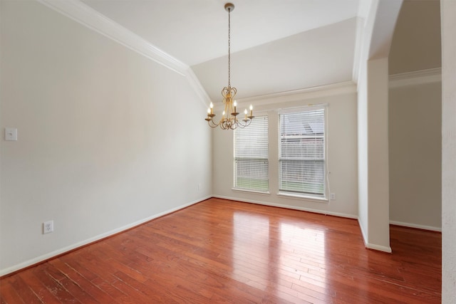 unfurnished dining area with crown molding, wood finished floors, vaulted ceiling, and an inviting chandelier