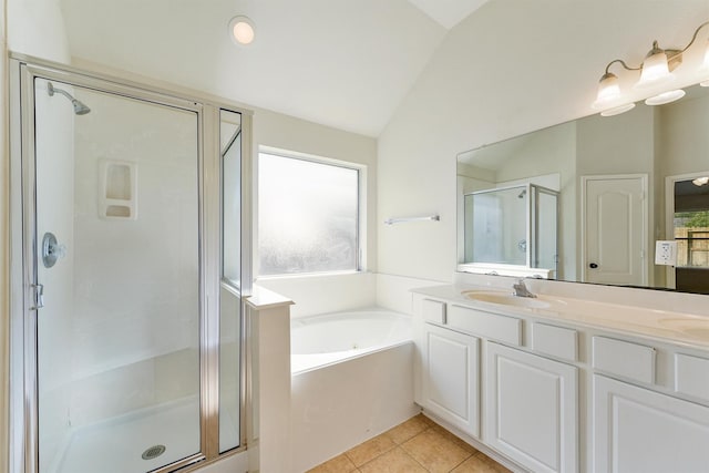 full bathroom featuring a garden tub, tile patterned flooring, lofted ceiling, a shower stall, and a sink