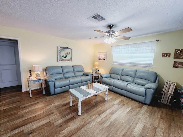 16607 Henry Morgan Rd, Jamaica Beach, TX 77554 - living area featuring visible vents, a ceiling fan, a textured ceiling, and wood finished floors