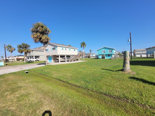 16607 Henry Morgan Rd, Jamaica Beach, TX 77554 - exterior space with stairs, a yard, and driveway
