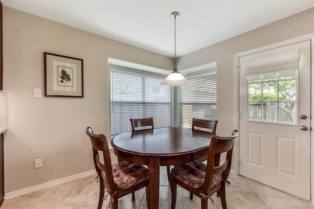 dining area featuring baseboards and light tile patterned floors