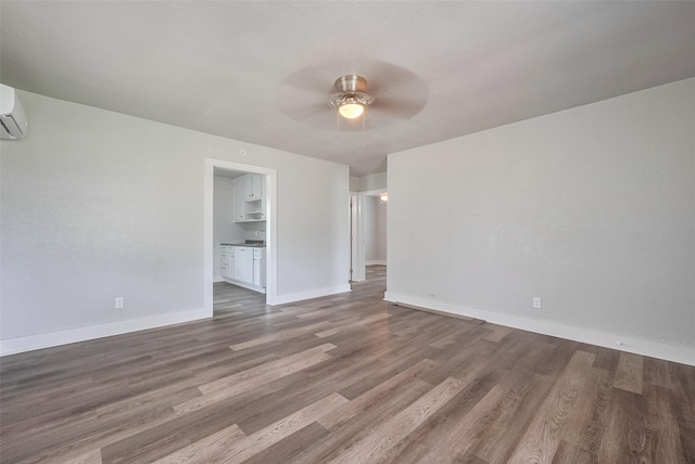 unfurnished room featuring baseboards, a ceiling fan, and wood finished floors