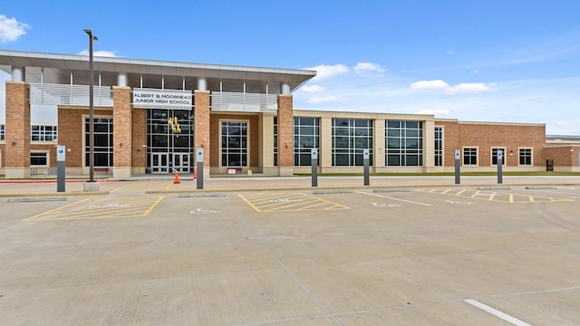 view of property featuring uncovered parking