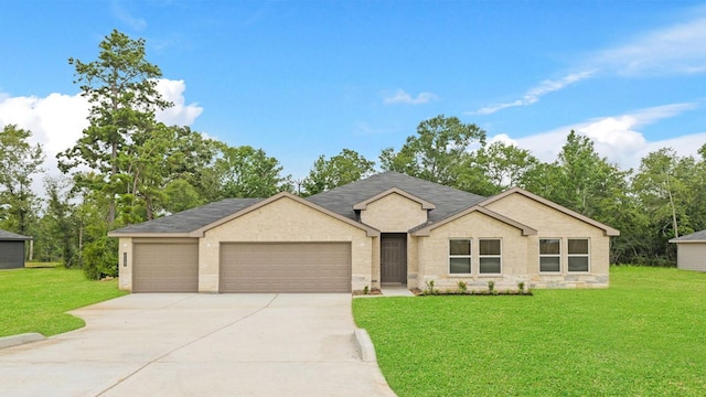 11143 Williams Reserve Dr, Conroe, TX 77303 - ranch-style home with concrete driveway, a garage, a front yard, a shingled roof, and stone siding