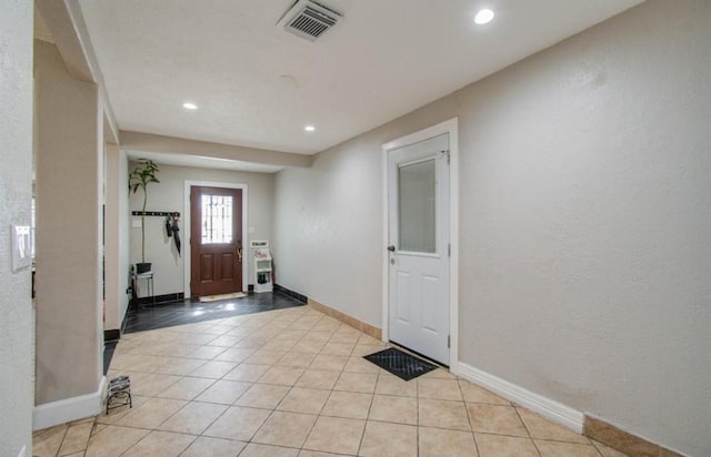 foyer entrance featuring recessed lighting, baseboards, visible vents, and light tile patterned floors