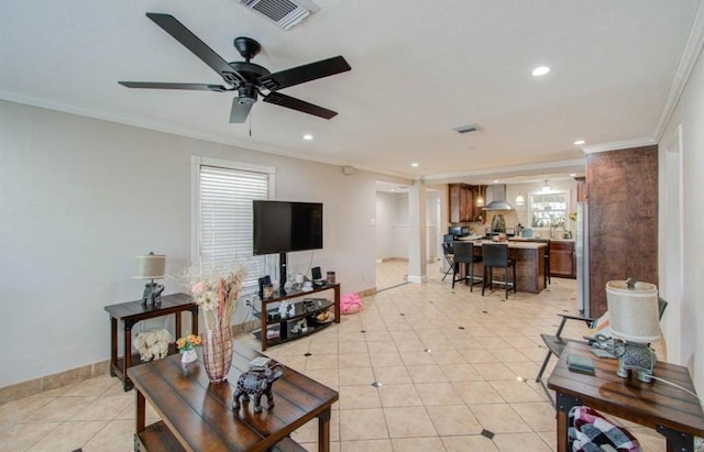 living room featuring crown molding, baseboards, light tile patterned flooring, and visible vents