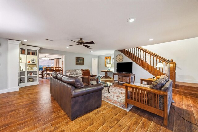 1033 Gardendale Dr, Houston, TX 77018 - living area with stairway, a ceiling fan, wood finished floors, and visible vents