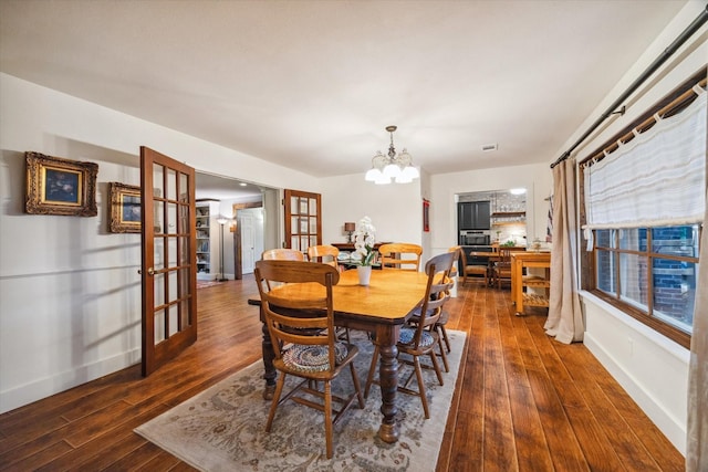 1033 Gardendale Dr, Houston, TX 77018 - dining area with french doors, visible vents, hardwood / wood-style flooring, baseboards, and a notable chandelier