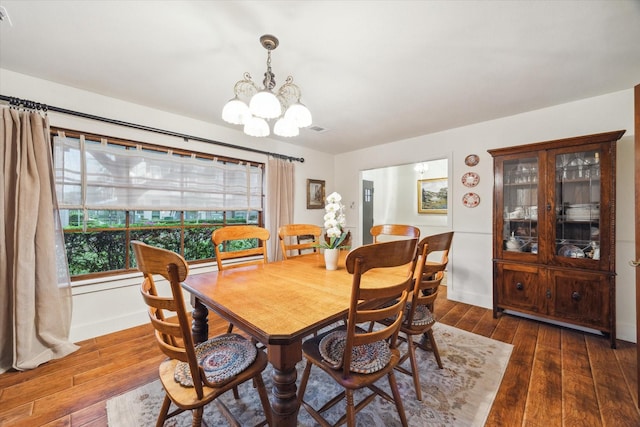 1033 Gardendale Dr, Houston, TX 77018 - dining space featuring baseboards, a notable chandelier, wood finished floors, and visible vents