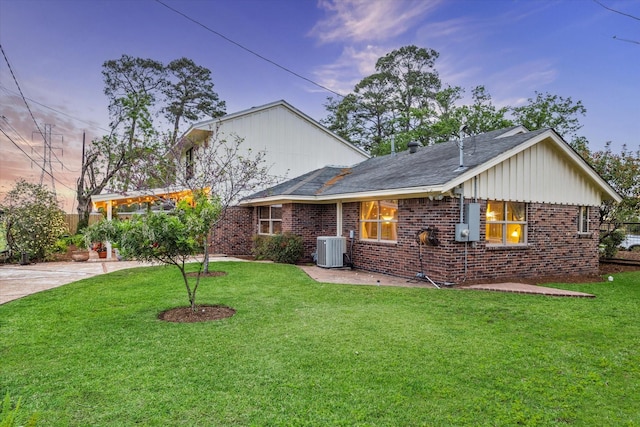 1033 Gardendale Dr, Houston, TX 77018 - view of front facade with brick siding, a front lawn, and cooling unit