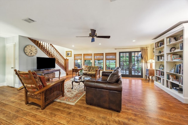 1033 Gardendale Dr, Houston, TX 77018 - living area with stairs, ceiling fan, visible vents, and hardwood / wood-style floors