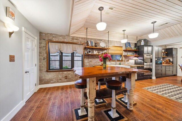 1033 Gardendale Dr, Houston, TX 77018 - dining room featuring wood-type flooring, baseboards, vaulted ceiling, and wood ceiling