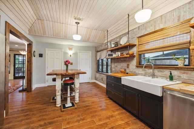 1033 Gardendale Dr, Houston, TX 77018 - kitchen featuring stainless steel dishwasher, wood-type flooring, baseboards, a sink, and wood counters
