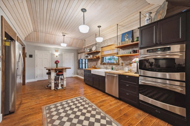 1033 Gardendale Dr, Houston, TX 77018 - kitchen featuring open shelves, baseboards, light wood-type flooring, a sink, and appliances with stainless steel finishes