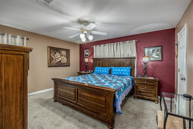 carpeted bedroom featuring baseboards, a textured ceiling, ceiling fan, and a textured wall