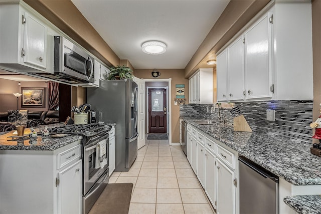 kitchen featuring a sink, appliances with stainless steel finishes, and white cabinets