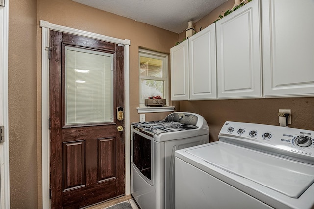 washroom featuring cabinet space and washing machine and dryer